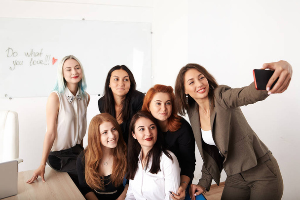 Jonge lachende zakelijke vrouwen nieuw project werken op kantoor. Collega's team van zakelijke bijeenkomst selfie foto maken. Analyseren van zakelijke documenten, conferentie, discussie, communicatie. Corporate concept. - Foto, afbeelding