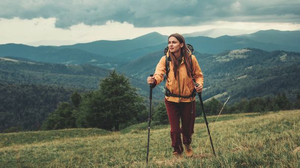 Full length of a sporty woman walking in the mountains - Φωτογραφία, εικόνα