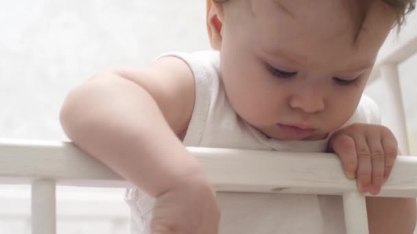Kid plays inbaby bed. - Footage, Video