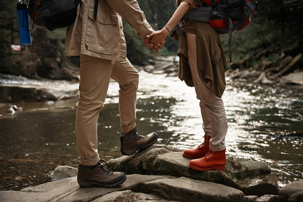 Romantic couple holding hands while standing face to face - Foto, imagen
