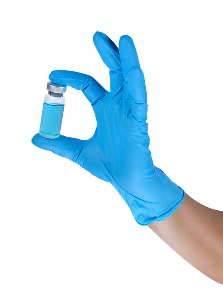 Mani di un medico che indossa guanti di lattice blu con campione liquido, chimico o biologico
. - Foto, immagini