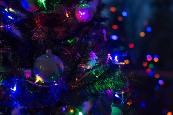 Decorated and illuminated Christmas tree at night, close up. Christmas background. - Photo, Image