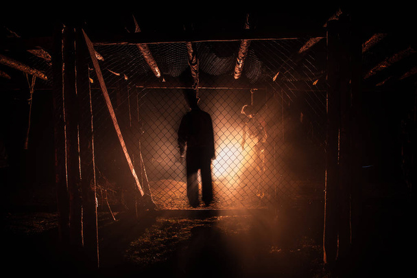 Horror view silhouette of hanged man on scaffold at night with fog and toned light on background. Execution (or suicide) decoration. Horror Halloween concept. - Photo, Image