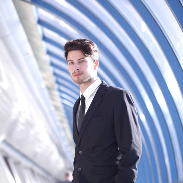 Young Businessman standing in corridor of modern office building - Foto, immagini