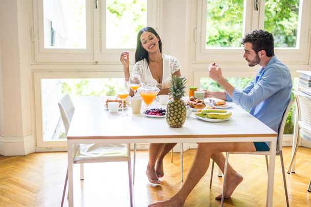 Happy couple having healthy breakfast at home in the morning - Happy moments of domestic partnership - Photo, Image