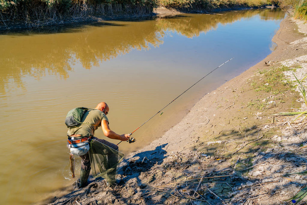 Spin fishing on a river with rod - Photo, Image