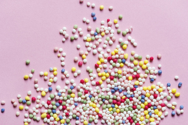 Sugar sprinkles on pink background - Foto, imagen