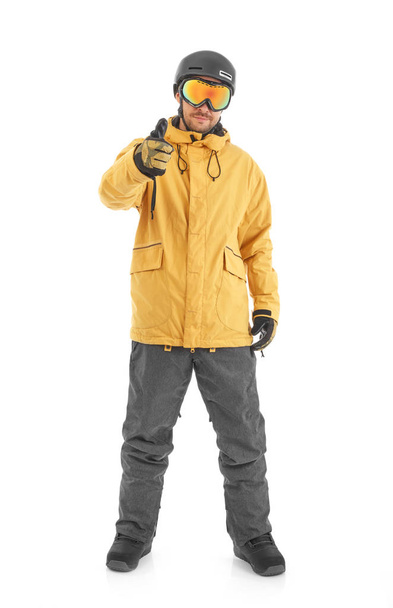 Young snowboarder pointing, isolated on white - Fotó, kép