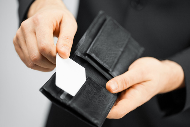 Man in suit holding credit card - Fotó, kép