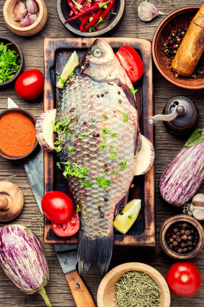 Fresh fish with ingredients for cooking on cutting board.Cooking concept.Healthy diet - Foto, Bild