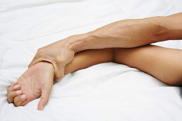 A mão de um homem peludo segurando uma mão de mulher para o conceito de estupro e abuso sexual
                                - Foto, Imagem