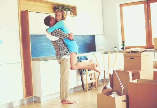 Portrait of young couple moving in new home. Young couple - Photo, Image
