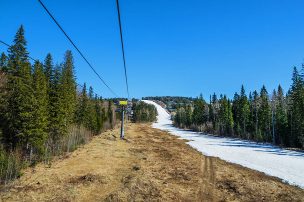 Remains of snow on the track on ski resort "Gora Belaya" in late spring. Russia, Urals - Photo, image