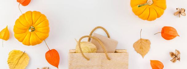 Creative Top view flat lay autumn composition Shopping bag dried orange flowers leaves pumpkins background copy space sale fall harvest thanksgiving halloween promotion flyers text Long wide banner - Photo, Image