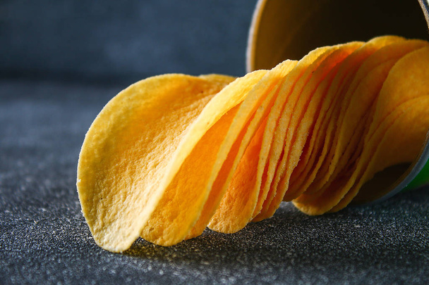 Crispy chips in a jar on a gray dark table. Snack - Photo, Image