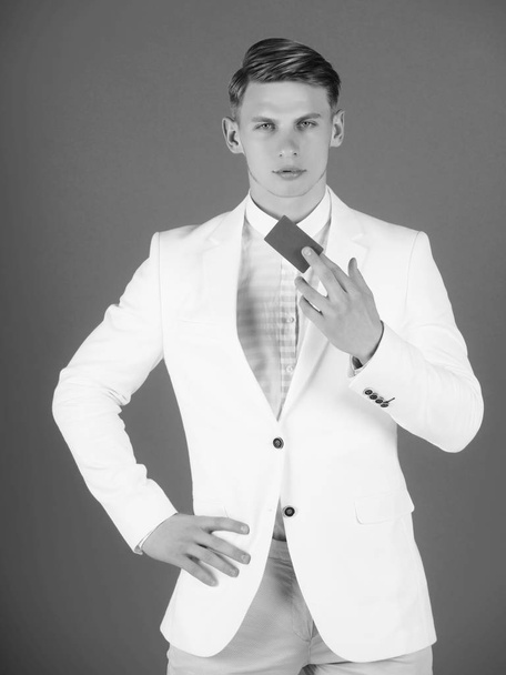 Businessman posing in white jacket, shirt and pants - 写真・画像