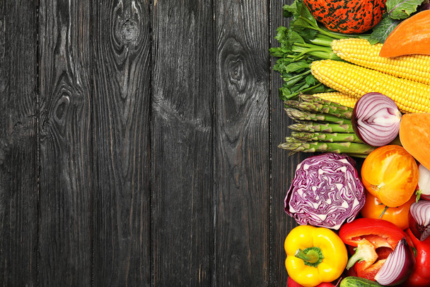 Flat lay composition with fresh vegetables and space for text on wooden background - Photo, Image