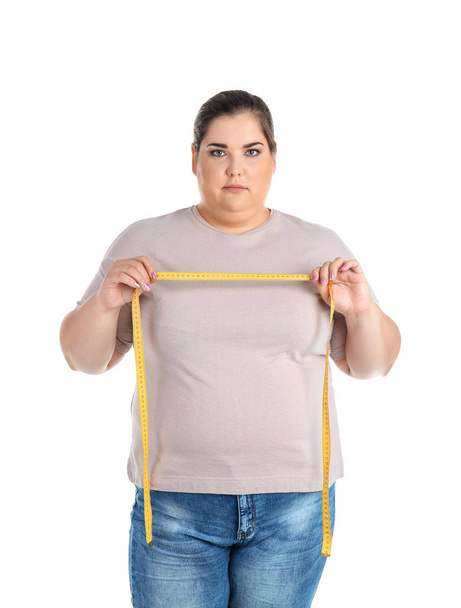 Overweight woman with measuring tape on white background - Foto, immagini