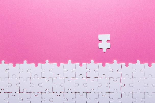 White puzzle on pink background. Top view - Foto, immagini