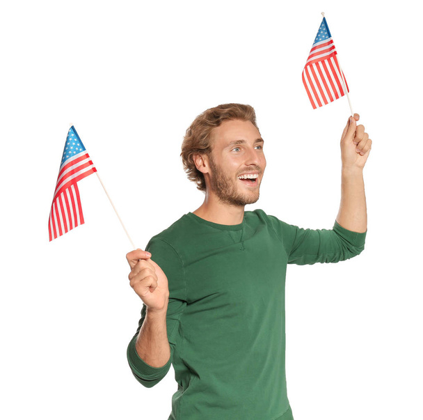 Young man with American flags on white background - Valokuva, kuva