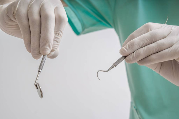 Dentist is holding dental instruments in hands. - Photo, Image