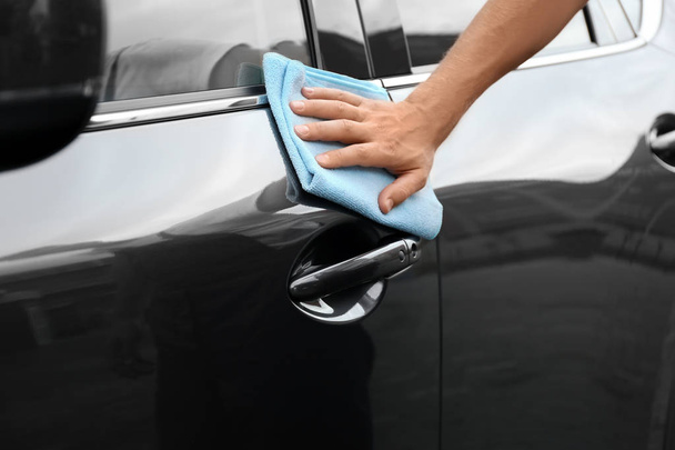 Man washing car door with rag, closeup - Fotó, kép