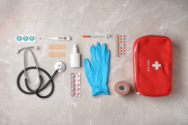 Flat lay composition with first aid kit on gray background - 写真・画像