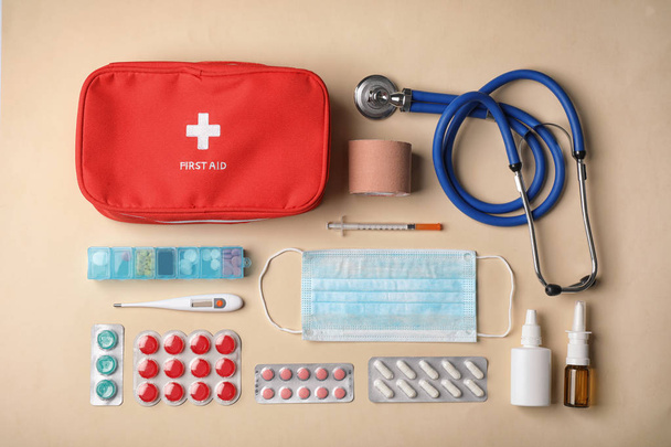 Flat lay composition with first aid kit on color background - Фото, изображение