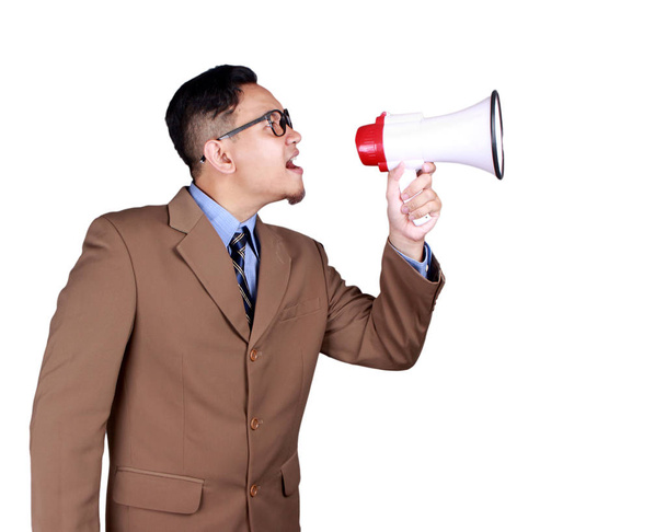 Young Asian businessman wearing shouting with megaphone, angry expression. Close up body portrait, side view isolated on white - Fotoğraf, Görsel