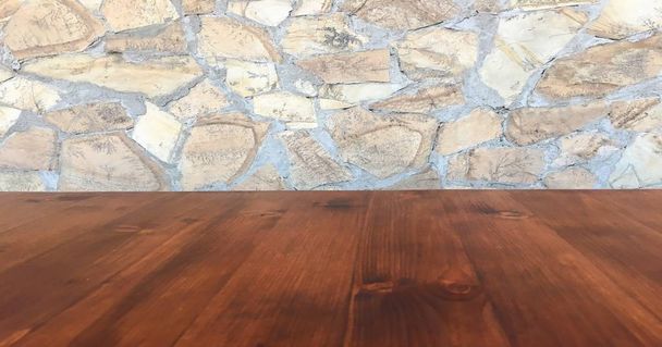 Σανίδες καφετί ξύλινος πίνακας πάνω σε άσπρη πέτρα θολή τοίχου υπόβαθρο από κτίριο διάδρομο - μπορεί να χρησιμοποιηθεί για την επίδειξη ή μοντάζ τα προϊόντα σας. Τραπέζι από ξύλο προοπτική και πέτρινο τοίχο bokeh θολή για το φυσικό υπόβαθρο - Φωτογραφία, εικόνα