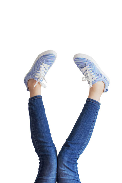 Woman legs in a blue jeans on white background isolated - Foto, imagen