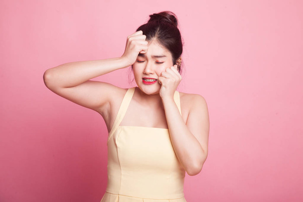 Young Asian woman got sick and  headache on pink background - Foto, imagen