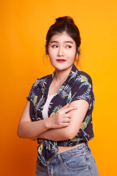 Portrait of beautiful young Asian woman in  tropical shirt on yellow background - Foto, immagini