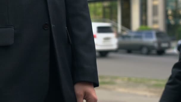 Handshake of two businesspeople standing near office, agreement, partnership - Video, Çekim
