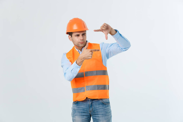 Young handsome architec man with wearing safety helmet over isolated background making frame with hands and fingers with happy face. Creativity and photography concept. - Fotoğraf, Görsel