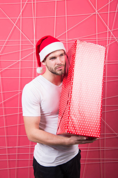 Ready to unpack your gift. Christmas holiday celebration. Man handsome unshaven santa hat hold gift box. Christmas gift concept. Santa bring gift for you. Man attractive santa claus carry big box - Φωτογραφία, εικόνα