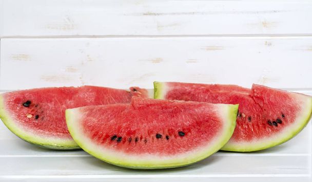 Watermelon slices on a wooden background - Foto, Bild