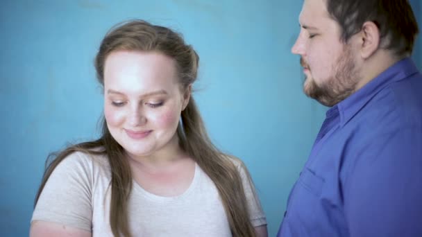 Caring fat girlfriend stroking boyfriends face, relation happiness, affection - Кадри, відео