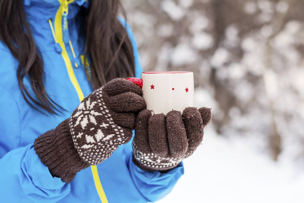 Beautiful Woman Drinking Hot Tea in the Winter Mountain.Winter Vacation - Photo, Image