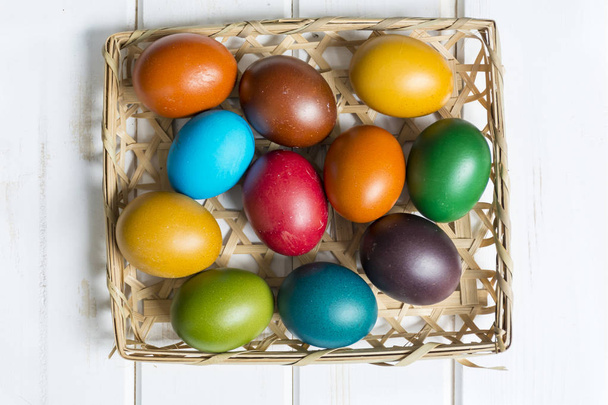 Easter eggs in the basket  on  wooden background - Fotoğraf, Görsel