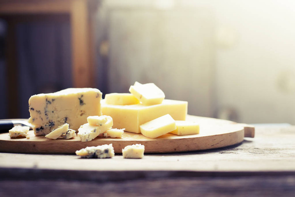 closeup view of tasty cheese on wooden chopping board - Fotoğraf, Görsel