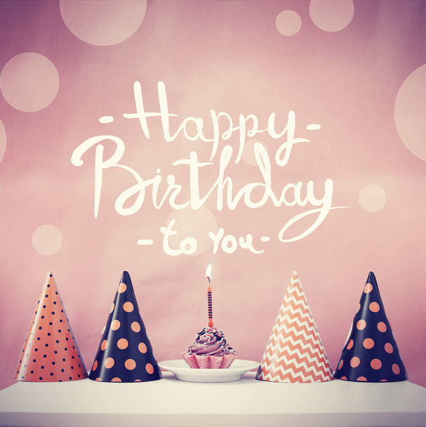 Birthday cake with candle and cone hats in vintage color, copy space - Foto, Bild