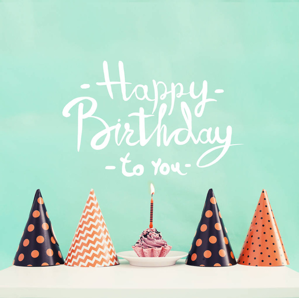 Birthday cake with candle and cone hats in vintage color, copy space - Фото, зображення