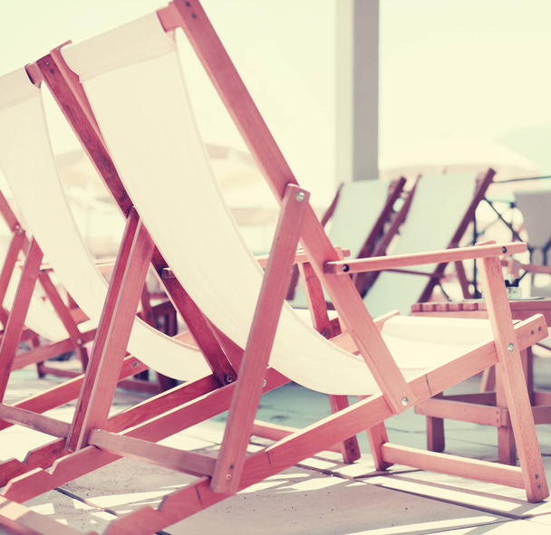 beach background with deck chairs near sea - Foto, Imagen