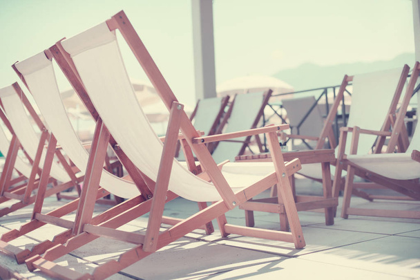 beach background with deck chairs near sea - Foto, Bild