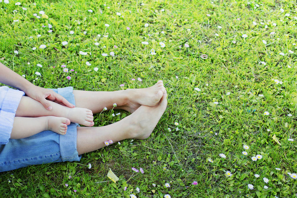 low section view of mother and son feet on grass - Fotó, kép