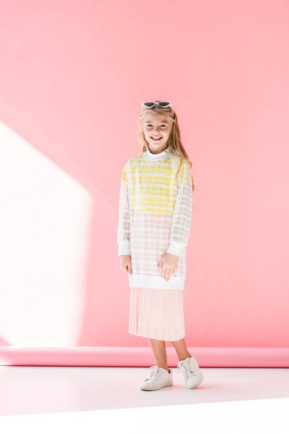 smiling fashionable preteen kid posing on pink - Фото, зображення