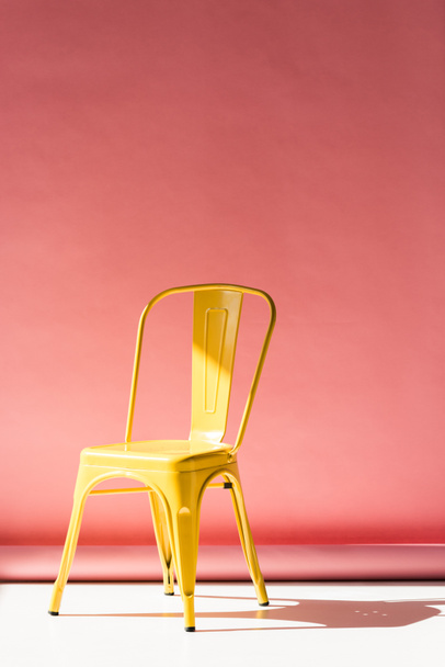 stylish yellow chair and on pink with copy space - Foto, Bild