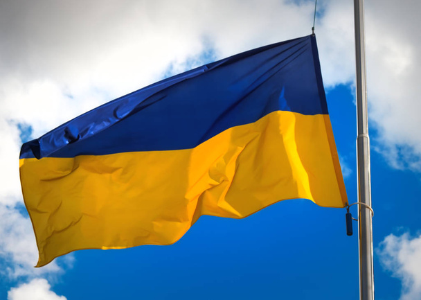 Flag of Ukraine against a blue cloudy sky. - Photo, Image