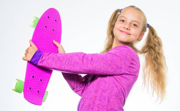 Plastic skateboards for everyday skater. Penny board of her dream. Best gifts for kids. Ultimate gift list help pick perfect present for girl. Child hold penny board. Kid long hair carry penny board - Zdjęcie, obraz